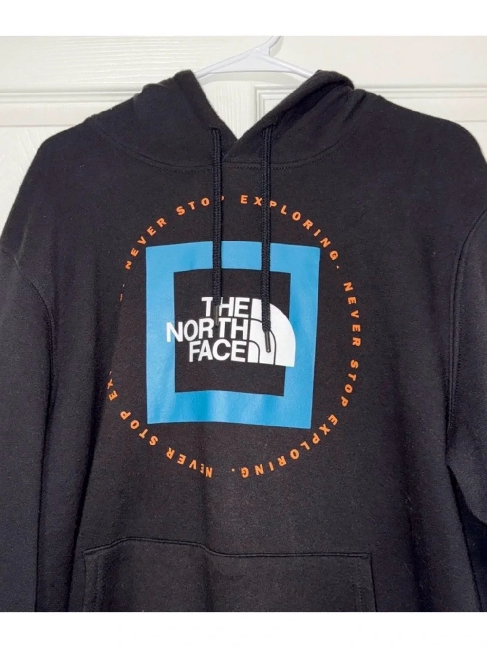 The North Face Black Pullover Hoodie with Blue Logo and Orange Accents